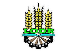 Grafika przedstawia logo Lubelskiego Ośrodka Doradztwa Rolniczego składające się z trzech kłosów pszenicy zlokalizowanych na górze, po środku znajdują się zielone litery LODR - skrót od Lubelskiego Ośrodka Doradztwa Rolniczego. Poniżej znajduje się połowa okręgu o kolorze czarnym z białym napisem Końskowola.