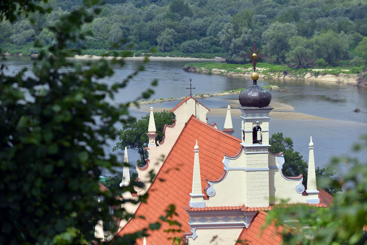 Dach kościoła farnego w Kazimierzu Dolnym. W tle Wisła