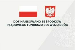 Zdjęcie przedstawia grafikę z polską flagą i godłem Polski po prawej stronie. Po lewej napis: "Dofinansowano ze środków Rządowego Funduszu Rozwoju Dróg".