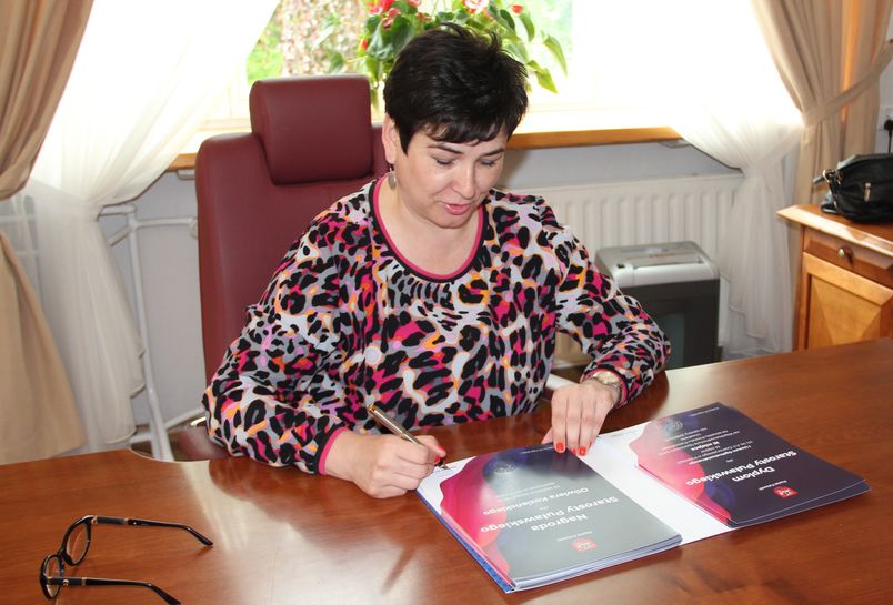 Starosta Danuta Smaga podpisuje dyplomy za osiągnięcia sportowe